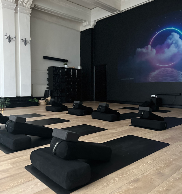 photograph showing the forest floor studio, showing bolsters and yoga mats ready for practice